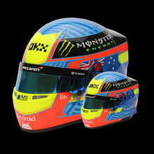 Load image into Gallery viewer, A miniature replica of an F1 racing helmet used by Oscar Piastri, featuring bright colors and Australian flag elements, alongside a real-size racing helmet.