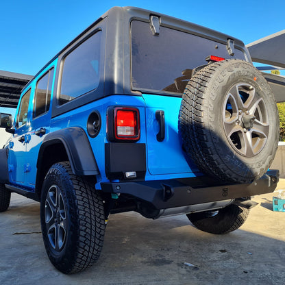 A close-up image of a blue Wrangler JL with a black RockRage OUTLAW Stubby Rear Bumper installed on the vehicle.